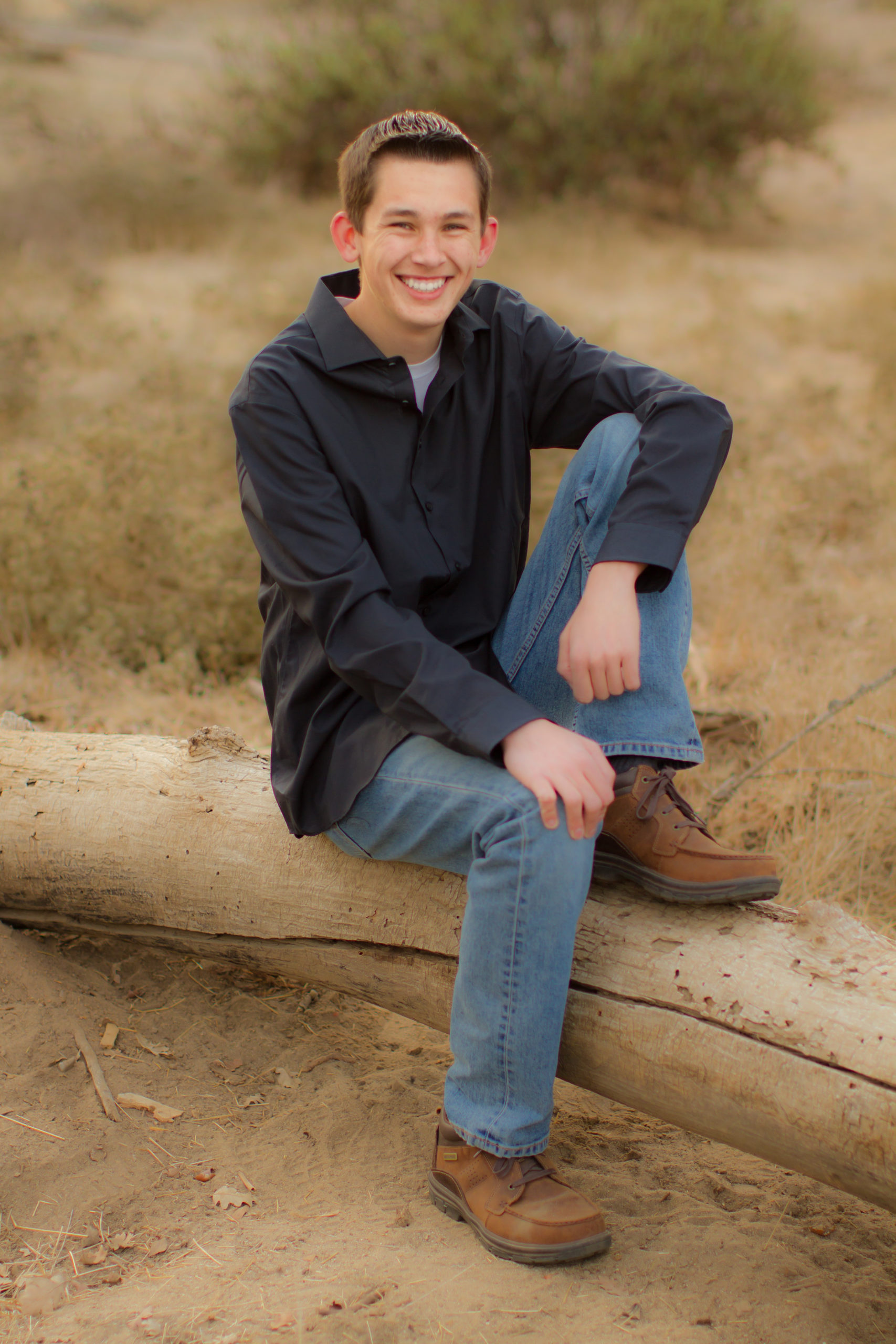 boy posing on log