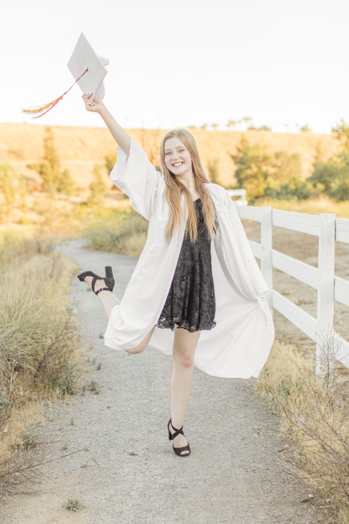 senior girl wearing cap and gown